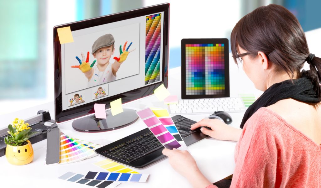 Graphic designer at work. Color swatch samples.